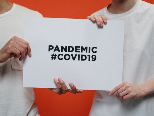 people-holding-white-paper-with-pandemic-covid19-text-3952234